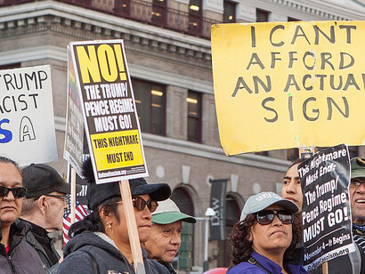Protesters hold signs at a Refuse Fascism rally in Union Square, San Francisco, USA