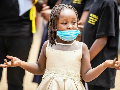 A young girl with her mask pulled down wondering what all the fuss is about concerning the coronavirus