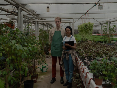 Driving sustainability forward, a dedicated individual practices eco-friendly farming in a greenhouse, showcasing a commitment to environmentally conscious agriculture and contributing to a more resilient and sustainable food production system