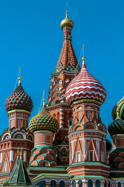 Saint Basil’s Cathedral rising against a clear blue sky in Moscow, Russia, representing the striking architectural character that first challenged the author’s preconceived image of the country