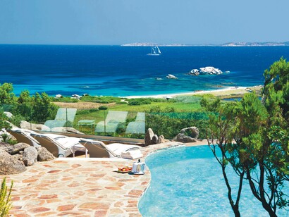 A poolside view of the clear and smooth waters of Valle dell’Erica in Northern Sardinia, Italy
