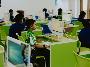 Students engaging with digital technology during a classroom lesson