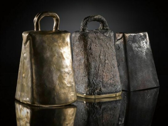Three recreated early Christian hand bells, each made using a different method, on display in Creative Spirit: Revealing Early Medieval Scotland