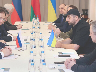Russian officals, left, and Ukrainian officials, right, during talks on February 28,2022 in the Gomel region of Belarus