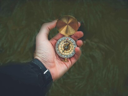 Someone holding an old-fashioned compass