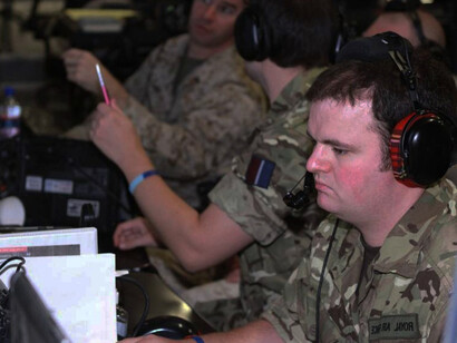 In Helmand Province, Afghanistan, Royal Air Force Sgt. Stuart McCaig, a 29-year-old tactical air director from Bothwell, Glasgow, monitors aircraft on his computer while working alongside U.S. Marines at the Regional Command (Southwest) Direct Air Support Center