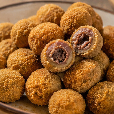 Olive all'Ascolana. Il simbolo dello street food marchigiano, dove l'oliva verde incontra un ricco ripieno di carne in una croccante panatura dorata