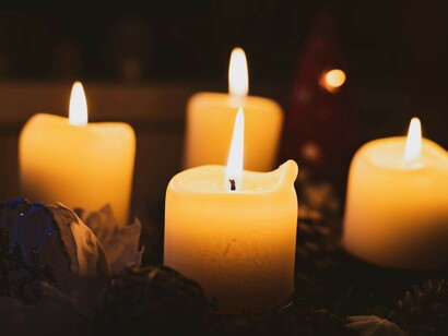 A single flame flickers in warm candlelight, guiding the path forward