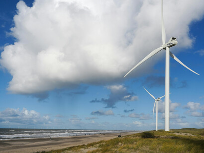 Hvide Sande, Denmark an idyllic beach scene where wind turbines rise along the coast, highlighting the harmony between natural beauty and renewable energy