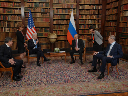 US President Joe Biden and Russian President Vladimir Putin having a discussion with other members
