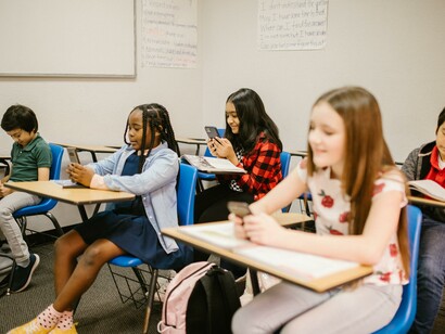 Students sending text messages in class