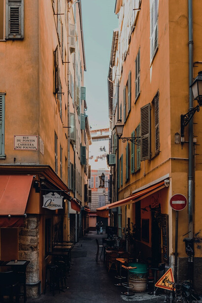 The rustic charm of the Old Side of Town in Nice, France, with its iconic concrete pathways winding between historic buildings along Rue du Pontin, offering a glimpse into the timeless beauty of this enchanting destination on the French Riviera