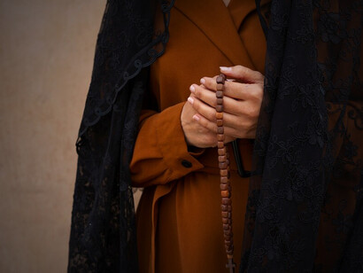 A woman embarks on a spiritual journey, standing in front of the church during her pilgrimage