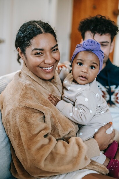 A mother holding her baby. Being rich can mean different things to different people 