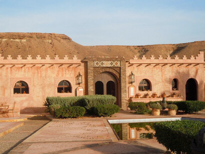 The Ksar Tafnidilt in Tan-Tan, Morocco, exudes an aura of elegance and grace amidst the splendour of the Moroccan sunset, inviting visitors to indulge in the timeless charm of the desert oasis
