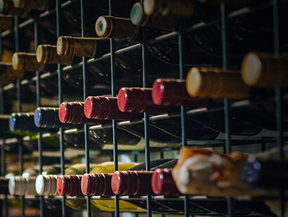 A sophisticated wine tasting experience showcasing award-winning wines elegantly arranged in a chic bottle rack