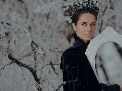 The evil queen gazes into the mirror, seeking validation of her beauty