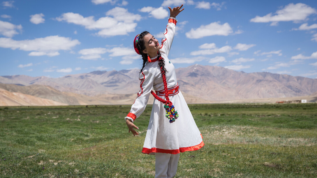 A girl in traditional Tajik dress dances at the opening of a new tourism centre in Bulunkul, a remote area in the Pamir mountains of Tajikistan.. Photo Credit Christopher Wilton-Steer and AKDN