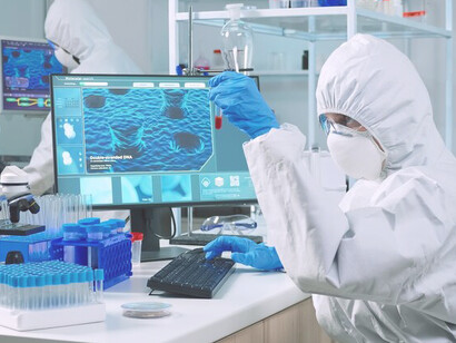 A focused scientist diligently analyzes specimens through a microscope, demonstrating a serious and concentrated demeanor in the laboratory