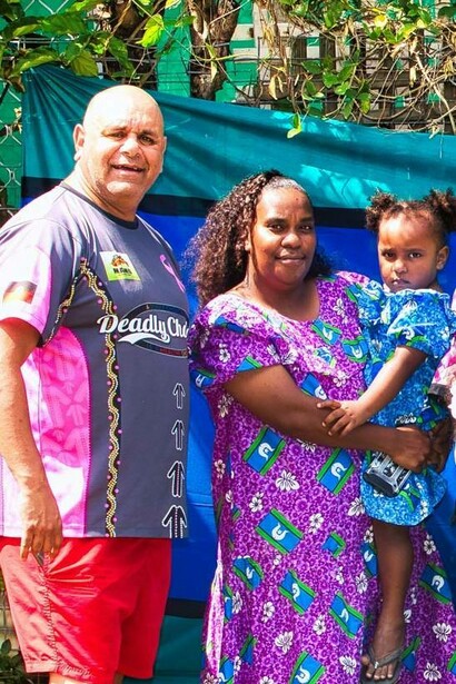 Family gathers by Torres Strait Island flag, Queensland, Australia