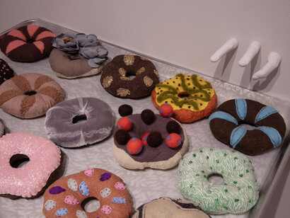 Eunkang Koh, Dreaming of Donuts, detail of installation, soft sculpture, trays and cast hands. Courtesy of Melhop Gallery°7077