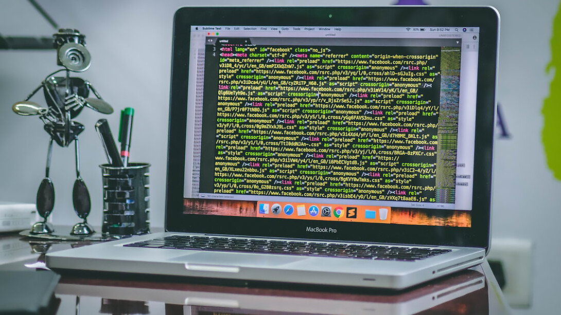 An open MacBook Pro displaying coding scripts, illustrating the integration of Web3 technologies