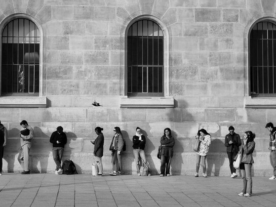 People standing outside a public office with no visible progress, showing  the hidden economic cost of lost time
