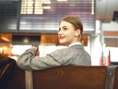 Stylish young woman sitting alone in the airport’s waiting area