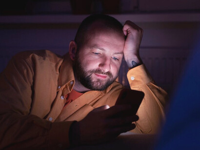 In the stillness of the night, his fingers trace the edges of a digital world that promises connection but leaves him more isolated than ever before