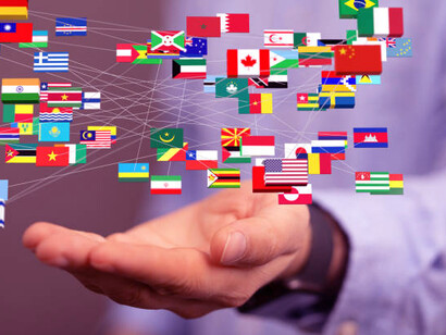 A person holding flags from various countries, representing international development projects and the cooperation between the Global South and North to promote sustainable development