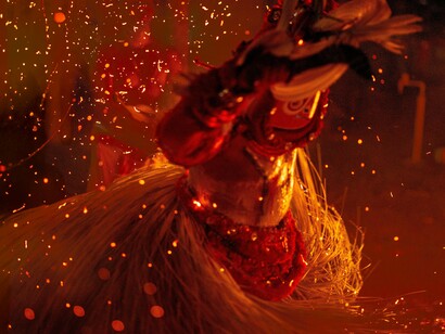A ceremonial Theyyam artist performing amidst flickering flames, reflecting the timeless rituals that continue to shape Kerala's cultural identity