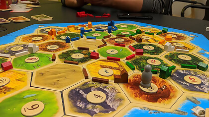 Embark on an exciting journey as players set up The Seafarers of Catan board, expanding the gameplay in this thrilling extension of the popular "The Settlers of Catan" board game
