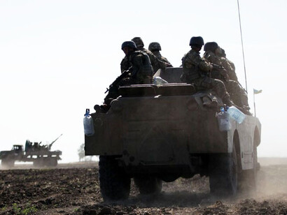 Scenes of war in Ukraine with troops on the ground and tanks in motion