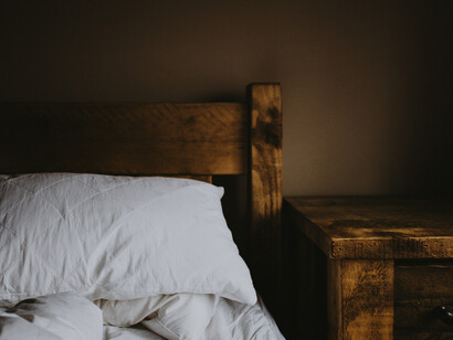 A wood-headboard bed is a place we take a rest 