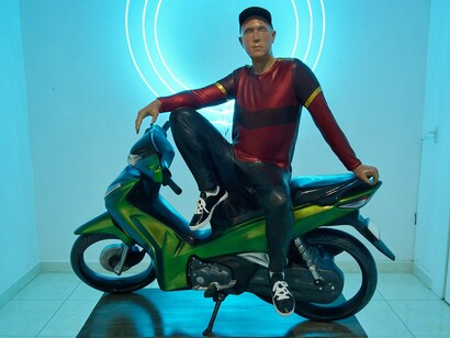 “Say Om” — Buehner’s self-portrait on a motorbike becomes a modern Bodhisattva, blending the everyday with spiritual symbolism