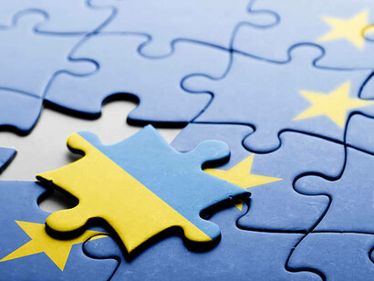 A puzzle piece of Ukraine fits into the European Union, symbolizing its candidacy and the broader EU expansion