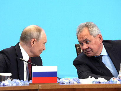 Vladimir Putin and Head of the Russian Security Council Sergey Shoigu are seen conversing during a regular session of the Collective Security Council of the Collective Security Treaty Organization, Astana, 28 November 2024