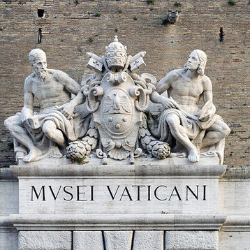 Vatican Museum sign and statue on outer wall, Rome, Italy