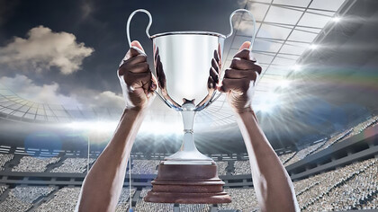 A triumphant hand grasping the UEFA Euro 2024 championship cup in victory, symbolizing the essence of champions