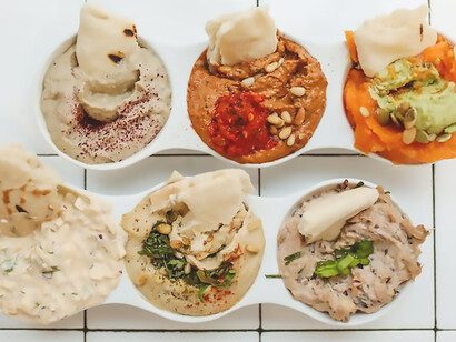 An array of hummus varieties takes center stage, each one a flavorful masterpiece in its own right