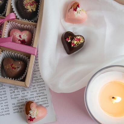 A close-up of a box of heart-shaped chocolates, symbolizing a romantic gift and the timeless sweetness of love