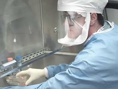 Taken in 2005, this photograph illustrates a staff microbiologist from the Centers for Disease Control (CDC) employing an electronic pipetter to withdraw the reconstructed 1918 Pandemic Influenza virus from a vial containing a supernatant culture medium