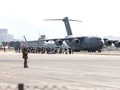 Evacuees board a United Arab Emirates Air Force Boeing C-17 Globemaster III during the evacuation on August 20, 2021, Afghanistan