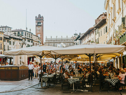 People dining al fresco at Piazza delle Erbe in Verona, Italy