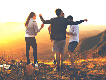 A group of people in an open field enjoying their social bonding; our ability to engage with the world, interact with it, and ultimately influence it sets us apart from other primates