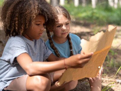 Children participating in a treasure hunt engage in exploration and problem-solving activities that promote learning and foster brain development through creative play
