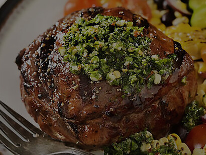 The culinary delight of a medium-rare Argentinian steak accompanied by the vibrant and flavorful Chimichurri sauce