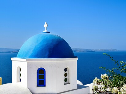 A church framed by sky and sea, depicting a visual reminder to live by the faith we claim