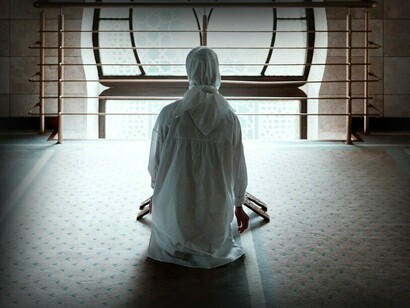 Muslim woman praying in a mosque