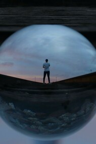 A person through a water droplet showing perspective 